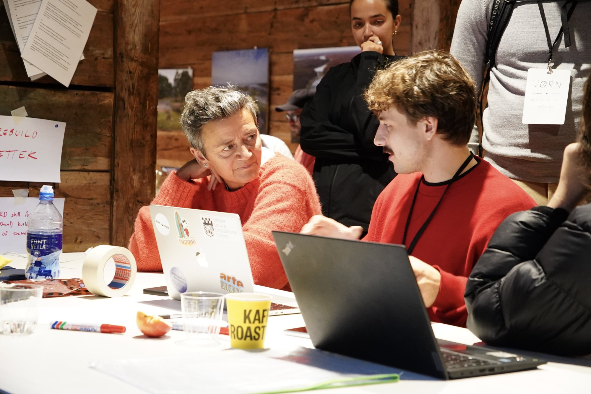 Two participants in conversation over their laptops during the Prototyping track at Rebuild 2.